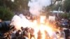 Armenia -Riot police fire stun grenades at antigovernment protesters outside the parliament building in Yerevan, June 12, 2024.