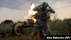 A Ukrainian soldier of the 3rd Separate Assault Brigade fires a 122mm mortar toward Russian positions at the front line near Bakhmut on July 2.