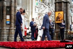 Британският крал Чарлз III и британският принц Уилям заедно с принцеса Катрин и кралица Камила минават покрай гроба на Незнайния воин в Уестминстърското абатство по време на благодарствената служба по случай 80-годишнината от Деня на победата в Европа.