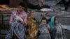 Деца седят близо до жилищна сграда, ударена по време на руската атака с дронове и ракети над украинската столица Киев. 28 август 2025 г.
