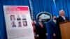 Издөөгө алынган орус хакерлеринин сүрөттөрү бар көрнөктүн жанында Федералдык иликтөө бюросунун (ФИБ) өкүлү Майкл Кристман (оңдо), Улуттук коопсуздук бөлүмүнүн өкүлү Жон Демерс (солдо) жана ФИБдин директорунун орун басары Дэвид Боудич турат. Вашингтон. 2020-жылдын 19-октябры. 