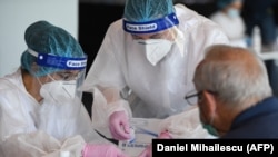 ROMANIA -- A man is tested for the novel coronavirus COVID-19 at the National Arena stadium in Bucharest, June 10, 2020