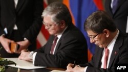 Армениянын тышкы иштер министри Эдуард Налбандян жана Түркиянын башкы дипломаты Ахмет Давутоглу тарыхый келишимге кол коюуда 