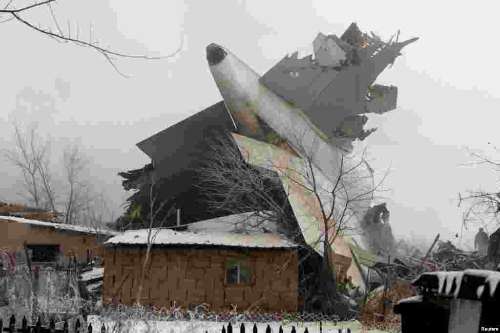 Уламок &laquo;Боїнга 747&raquo; між знищеними будинками селища Дача-Суу, у передмісті Бішкека.