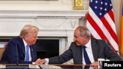 U.S. President Donald Trump shakes hands with Armenia's Prime Minister Nikol Pashinian during a trilateral signing event along with Azerbaijan's President Ilham Aliyev, in Washington, August 8, 2025.