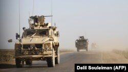 SYRIA -- U.S. armored vehicles patrol in the countryside of the eastern Syrian Deir Ezzor province, January 31, 2019