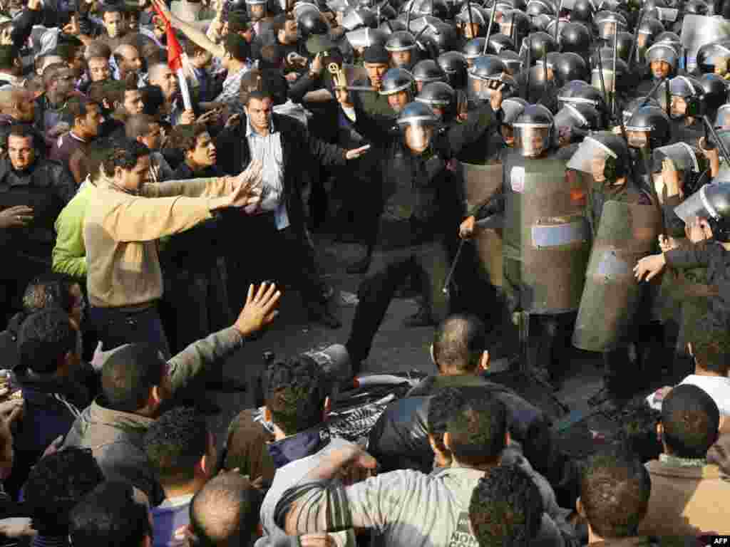 Demonstrators clash with police in central Cairo on January 25