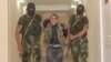 Azerbaijan - Azerbaijan soldiers escort Karen Petrosian, an Armenian man arrested after crossing into Azerbaijan, 7Aug2014 