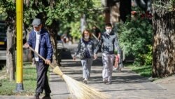 Люди идут по одной из центральных улиц Алматы.