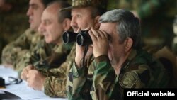 Nagorno Karabakh - Armenian President Serzh Sarkisian (R), watches military exercises in Karabakh, 13Nov2013