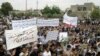 Antiregime protesters carry banners during a rally in Talbiseh, in the central Syrian province of Homs, last month.