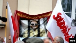 Праціўнікі Ярузэльскага нясуць плякат "Здраднік, узнагароджаны Пуціным"