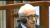 Hussein Regime's 'Public Face' Gets 15-Year Jail Term