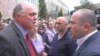 Armenia -- Gloria factory owner Bagrat Darbinian (L) and his employees argue with a police officer trying to prevent its renewed operations, Vanadzor, April 21, 2020.