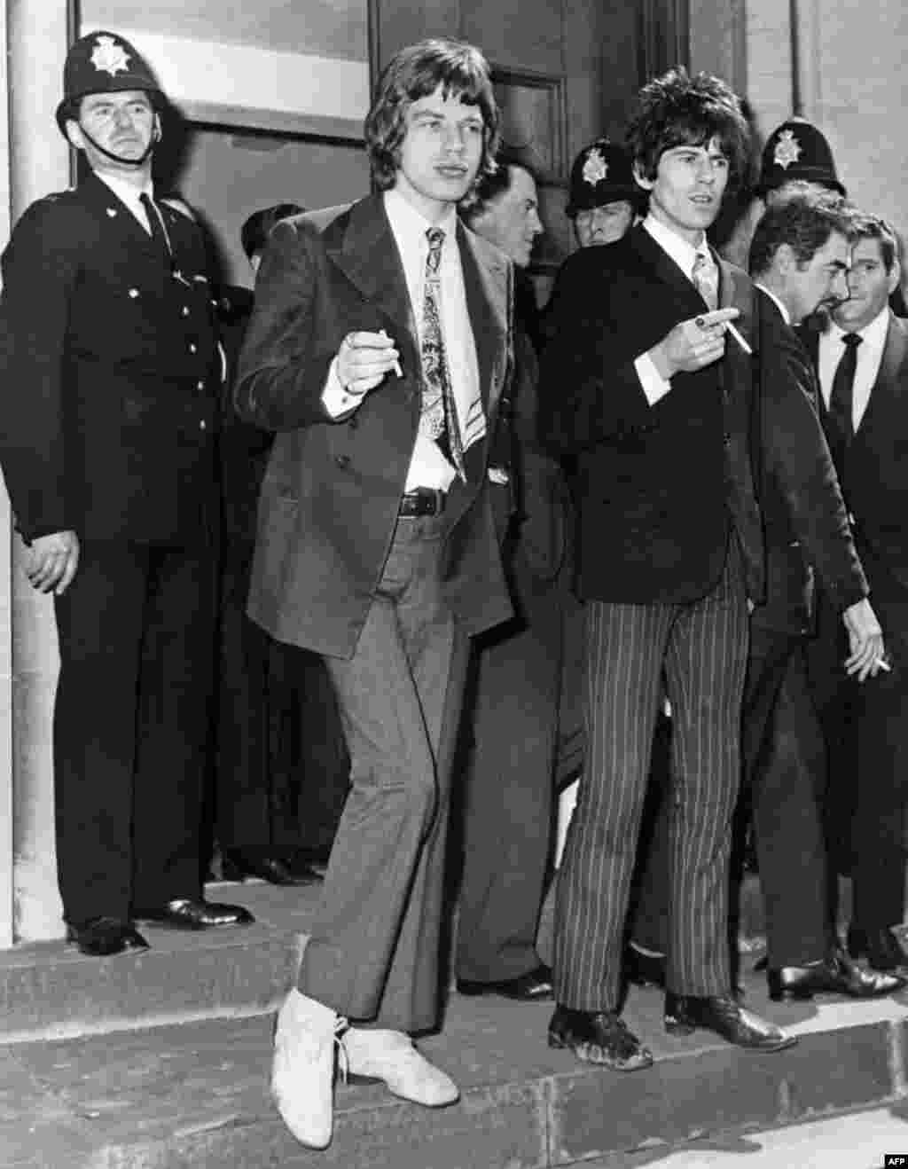 Jagger and Richards leave a court in Chichester, England, after being charged with drugs possession in 1967 following a police raid of Richards&#39; home. 